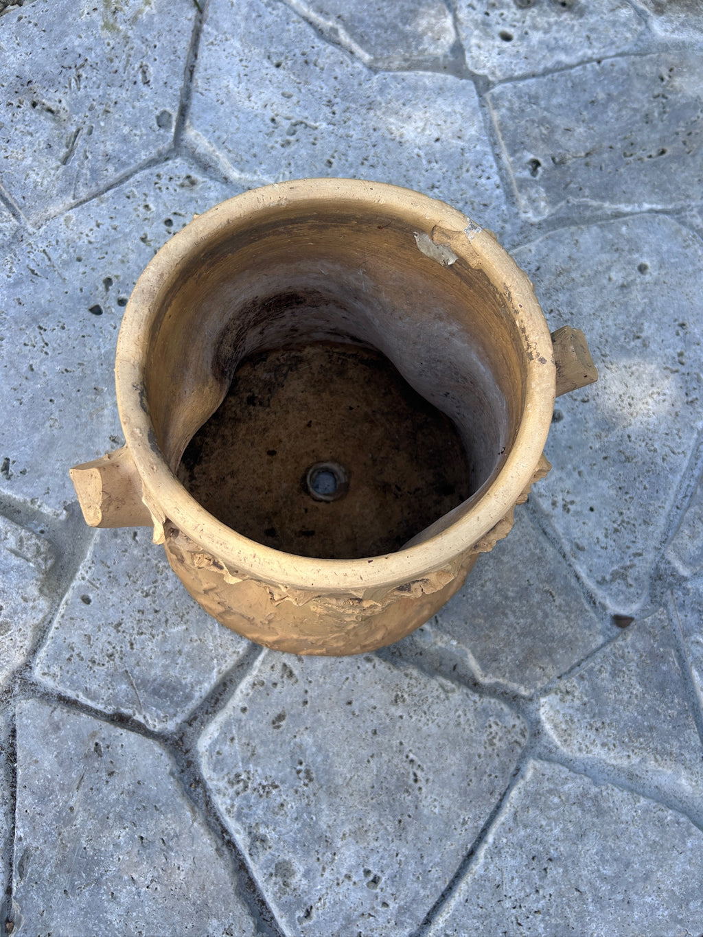 Top view of textured terracotta planter showing opening