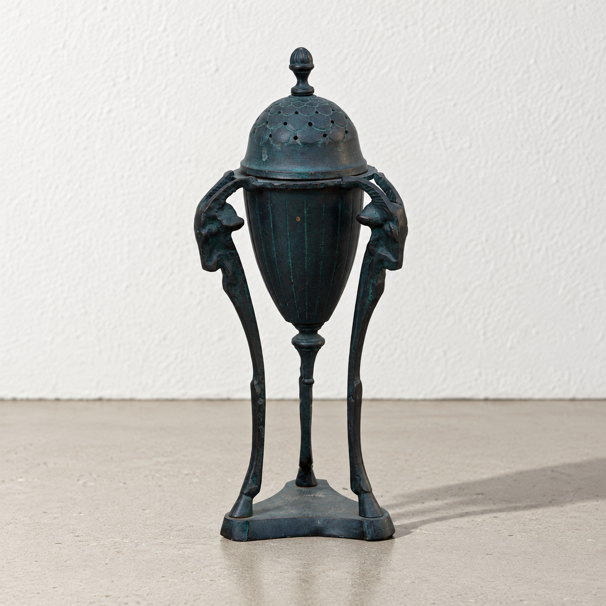 Art Nouveau style patinated metal incense burner with figural supports
