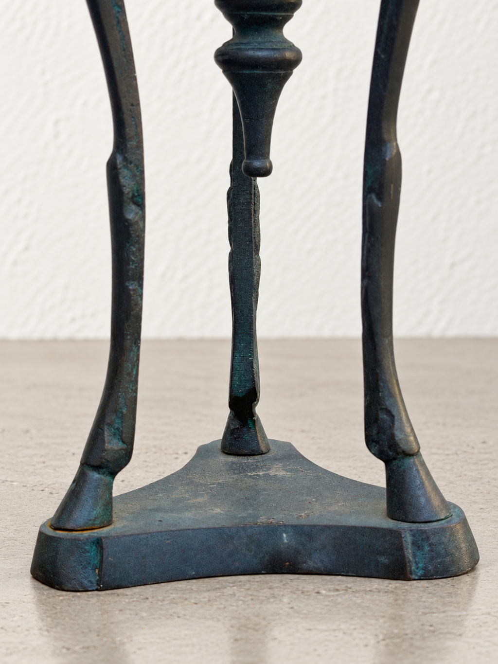 Base of patinated metal incense burner with decorative figures