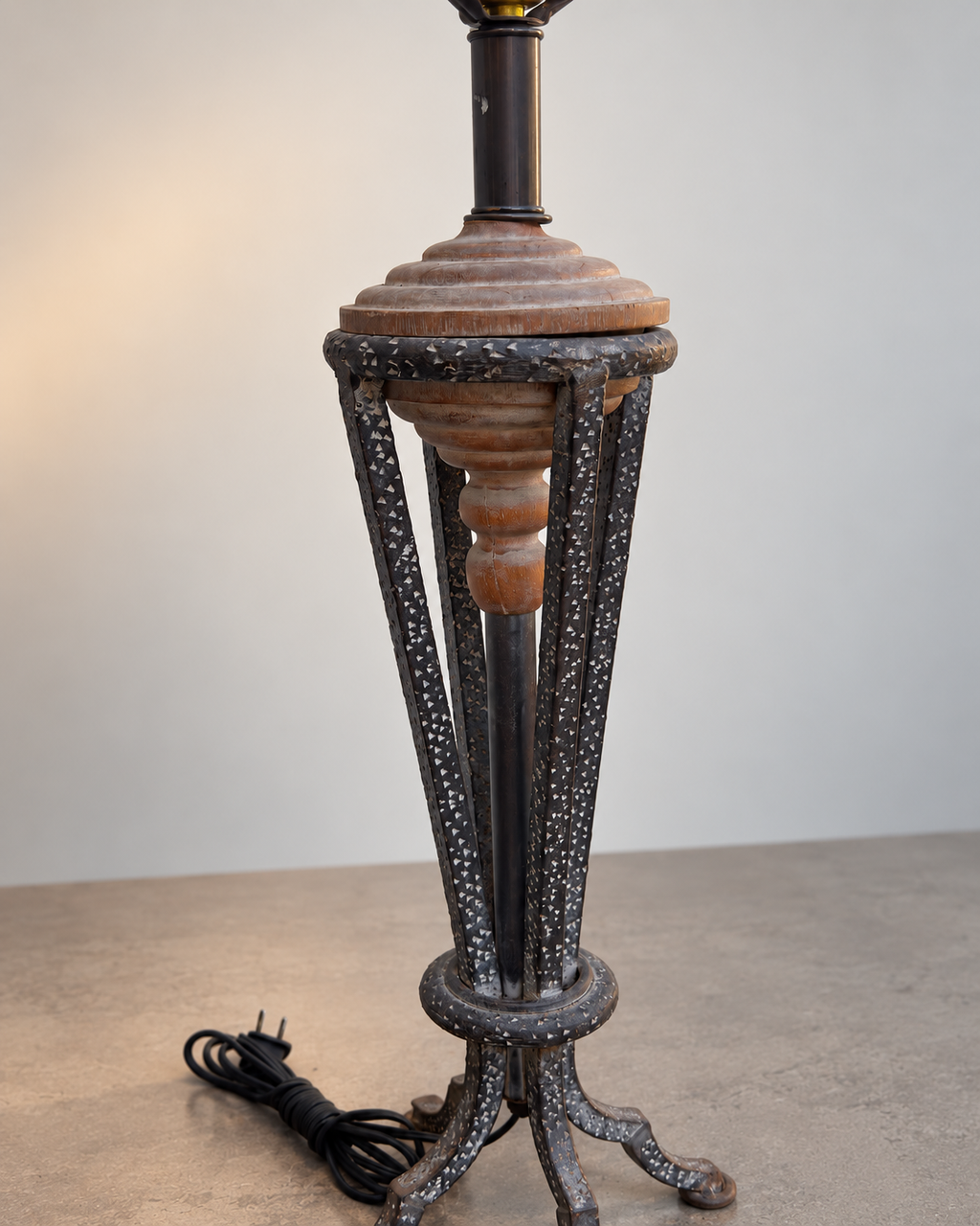 Side view of sculptural metal and wood table lamp