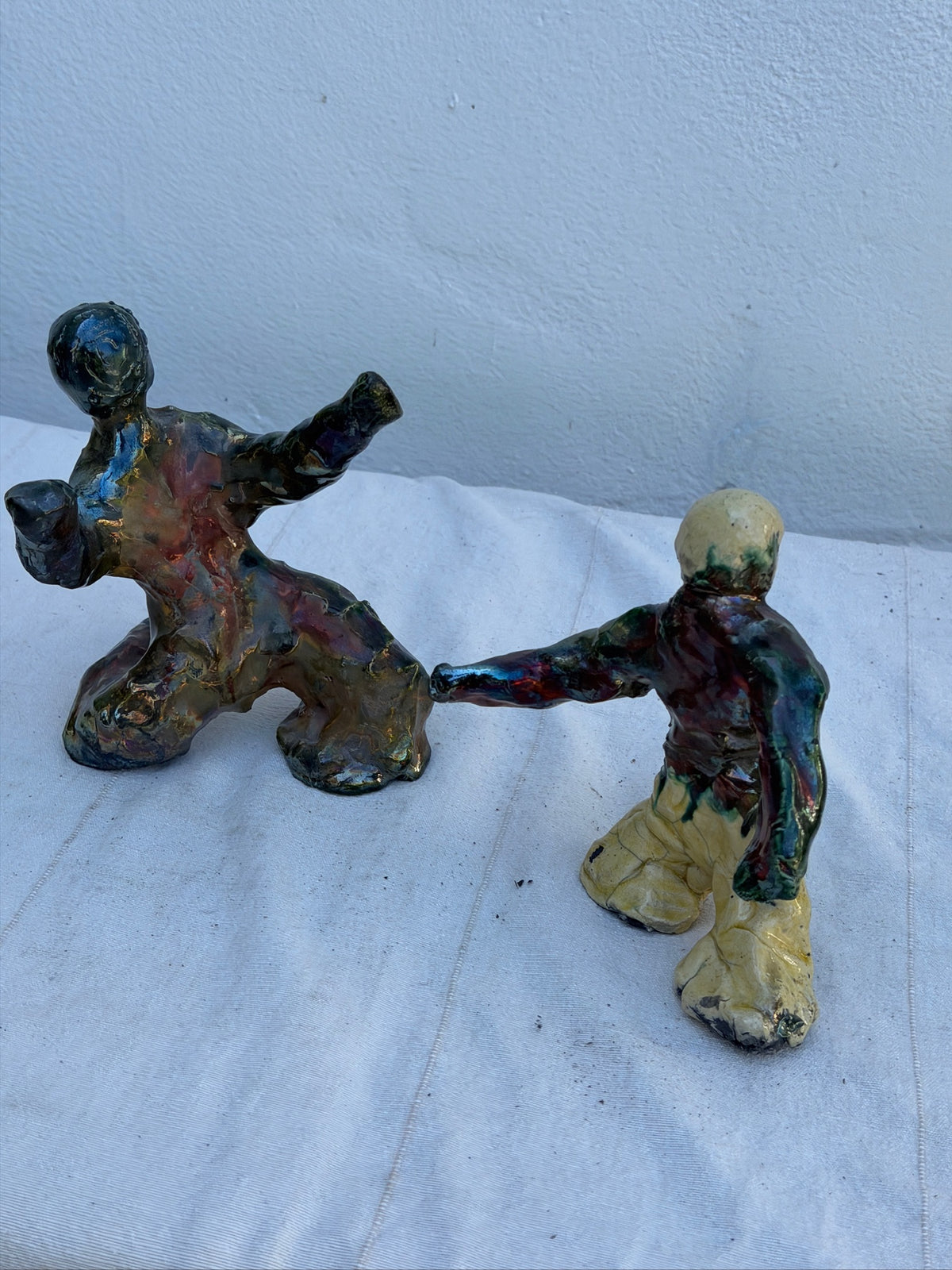 Abstract glazed ceramic figures displayed as a pair