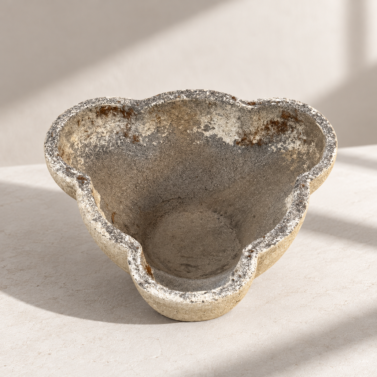 Sculptural concrete planter with organic clover-shaped rim