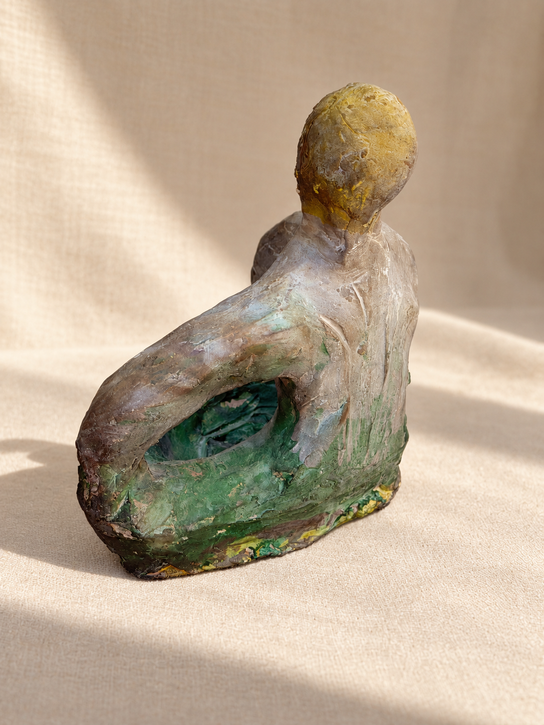 Signed studio pottery figure with earthy green and ochre tones