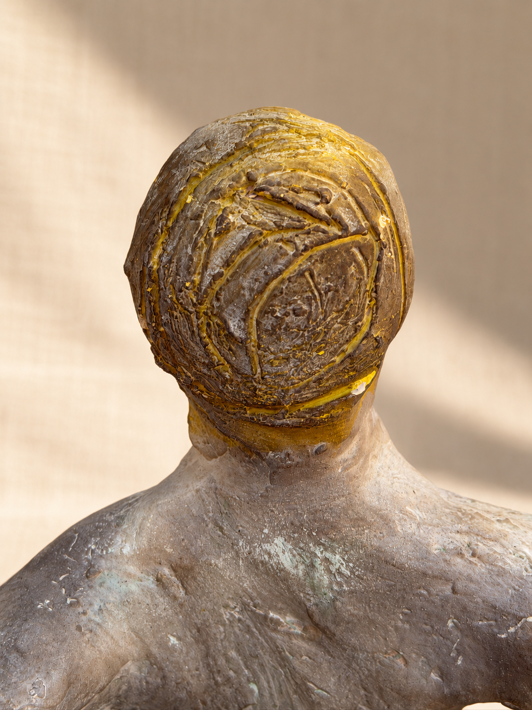Close-up of green and ochre decoration on ceramic sculpture