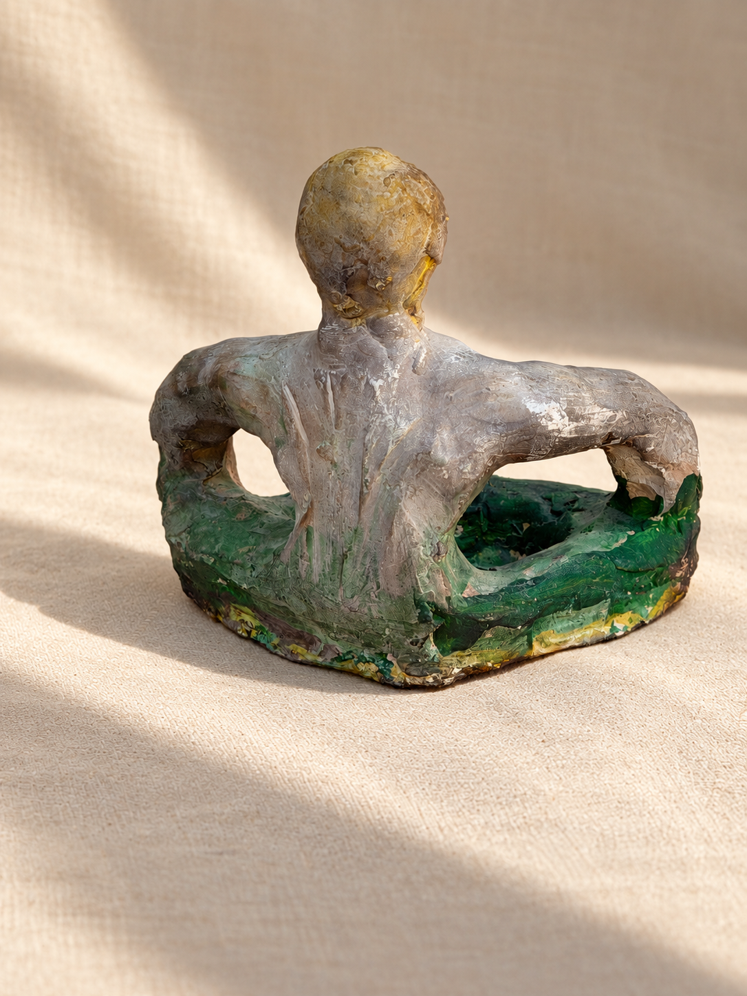 Reverse view of signed ceramic figural sculpture