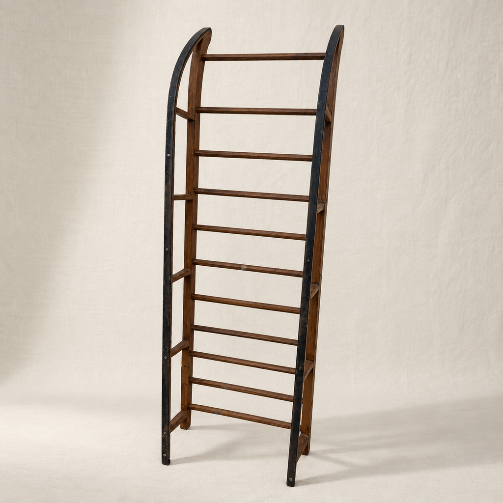 Primitive wood sled with open ladder frame and iron-shod runners