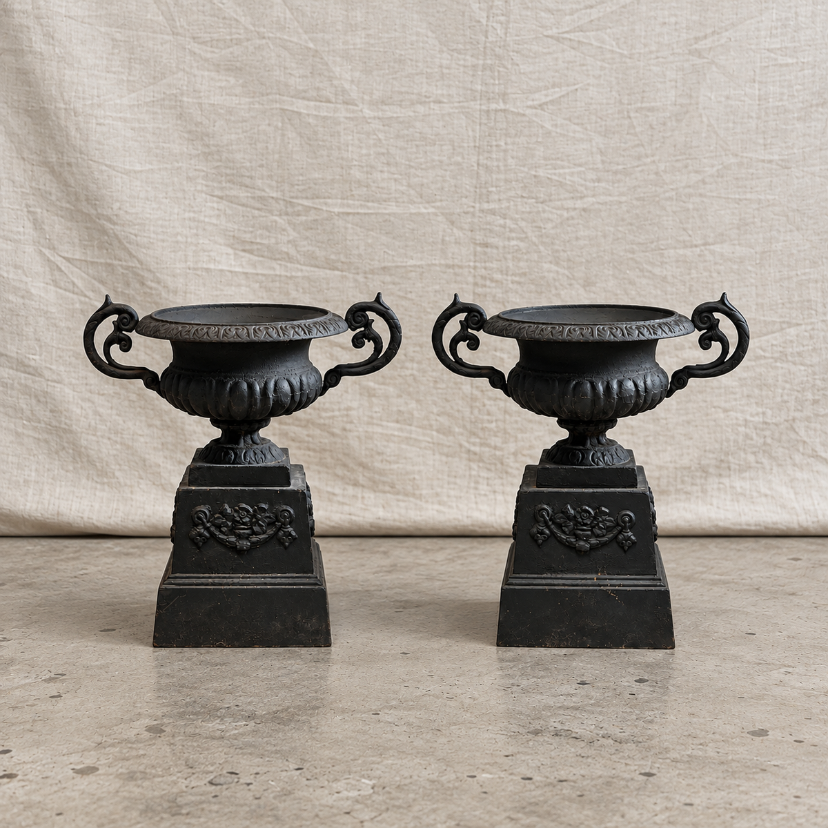 Pair of 19th-century Neoclassical black cast iron garden urns with C-scroll handles, weathered patina and matching plinth bases — Hommes and Gardens, Pots + Planters Collection, Objects + Curiosities Collection, Home Decor, Landscape Architect, Interior Designer, Outdoor Living, Outdoor Decorations, Garden Design, Home Design, Luxury Design, Art, Furniture, Objects, Best Gifts, Nature, Backyard, Yard.