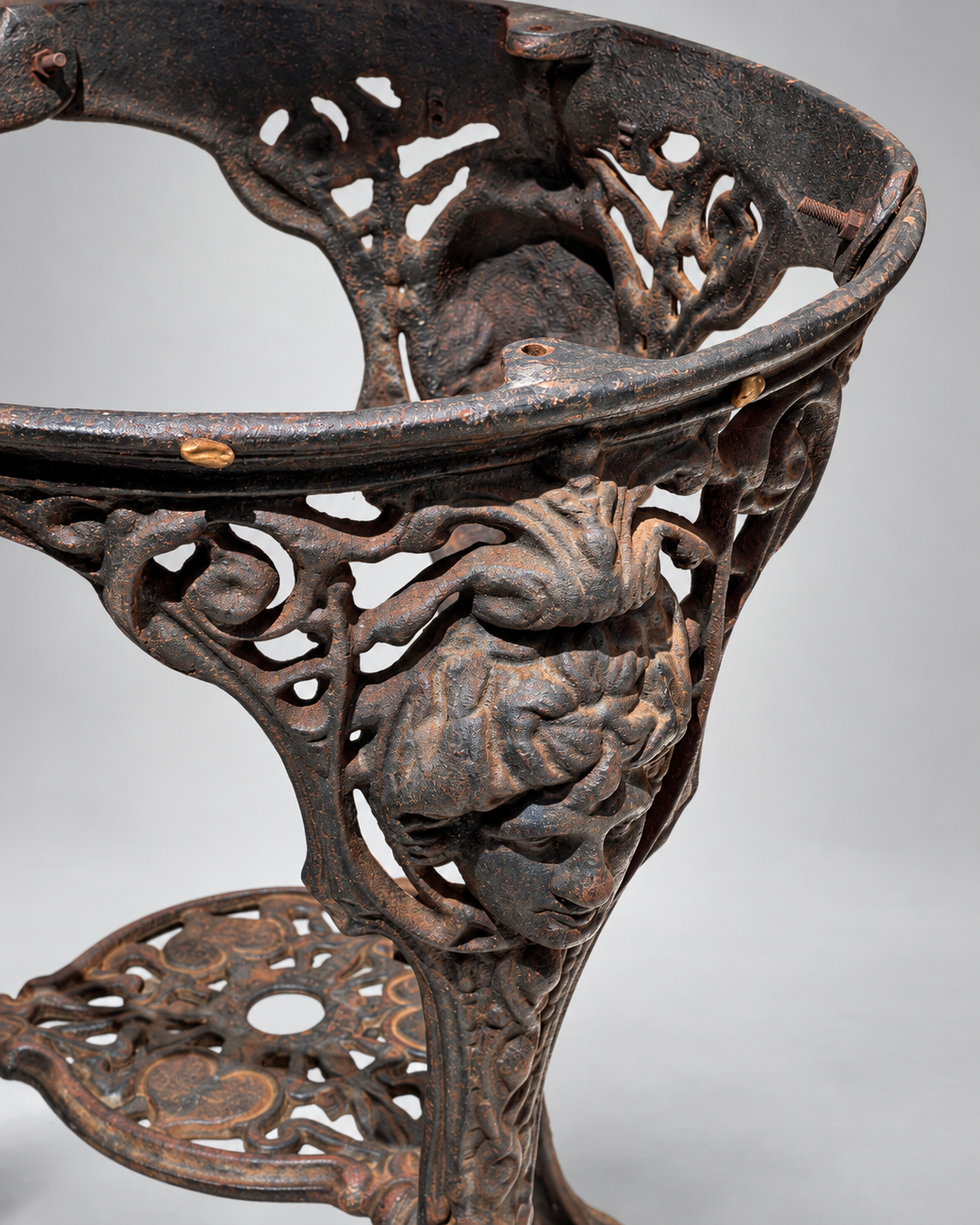 Close-up of ornate cast iron relief and shield motif on mid-century Britannia pedestal table — Hommes and Gardens, Furniture Collection, Objects + Curiosities Collection, Home Decor, Interior Designer, Luxury Design, Art, Furniture, Objects, Decorative Ironwork, European Design, Vintage Decor.
