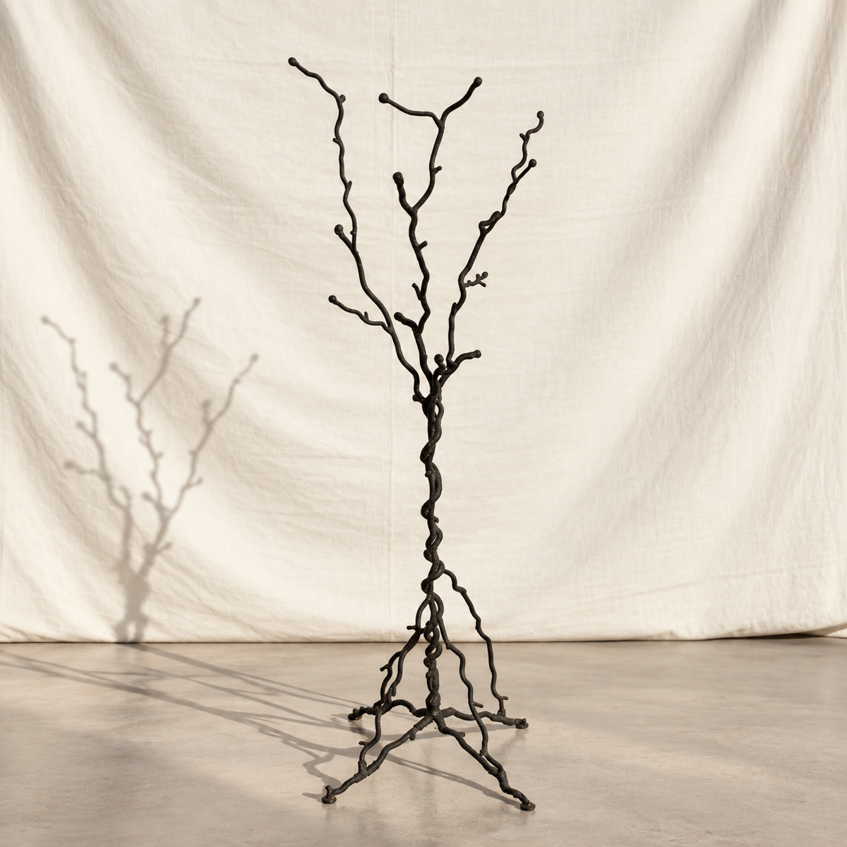 Sculptural tree-form metal floor stand with twisted trunk and root base