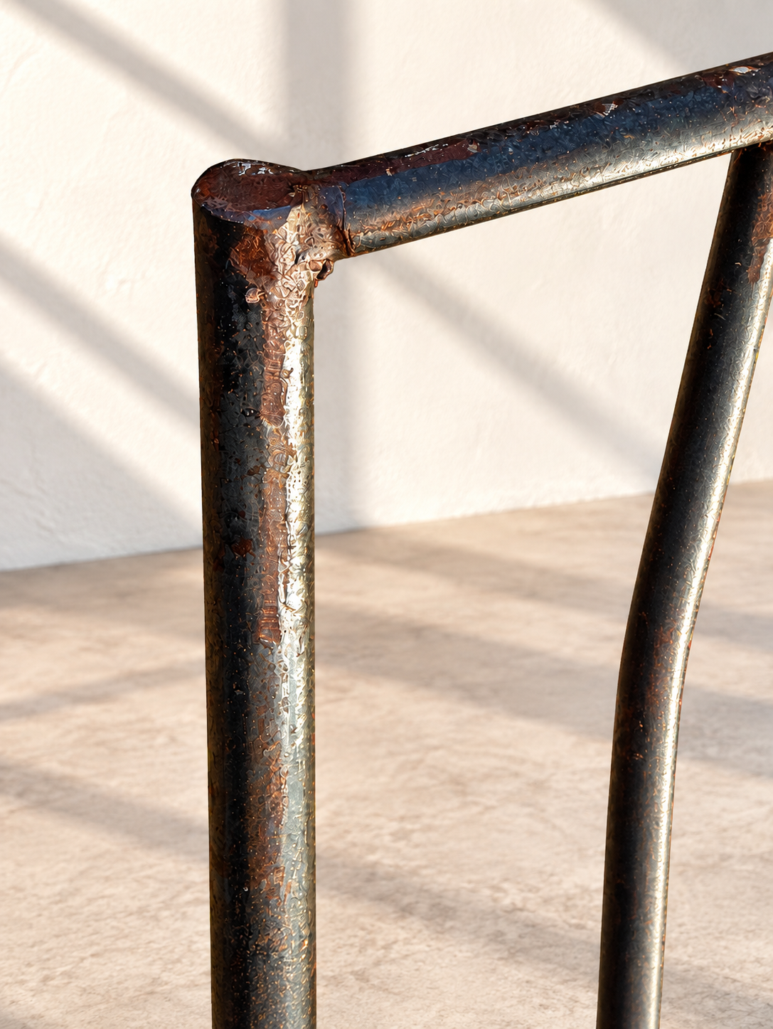 Slender wrought iron bar stool with curved back details