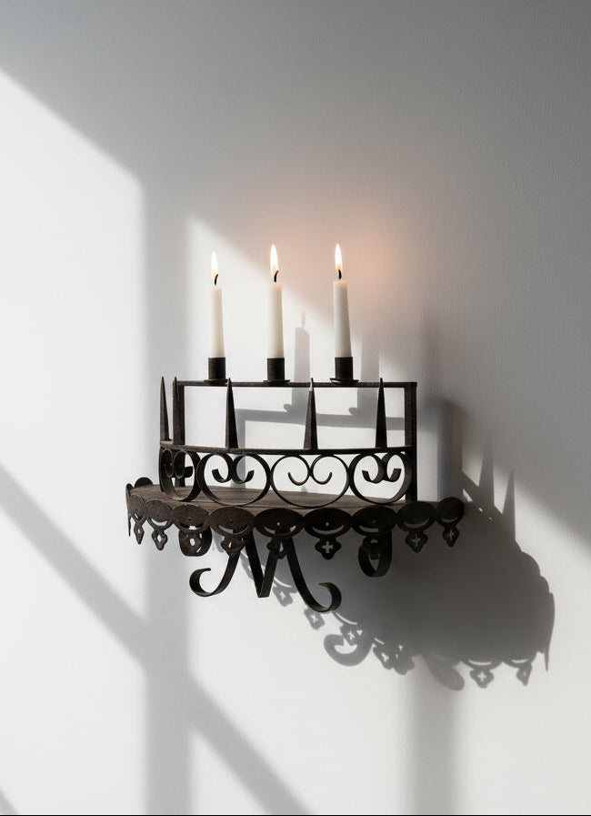 Set of two Antique Gothic Wrought iron Candle Wall Shelf or Sconce with three lit candles, shadows on the wall, hommes + gardens estudio.
