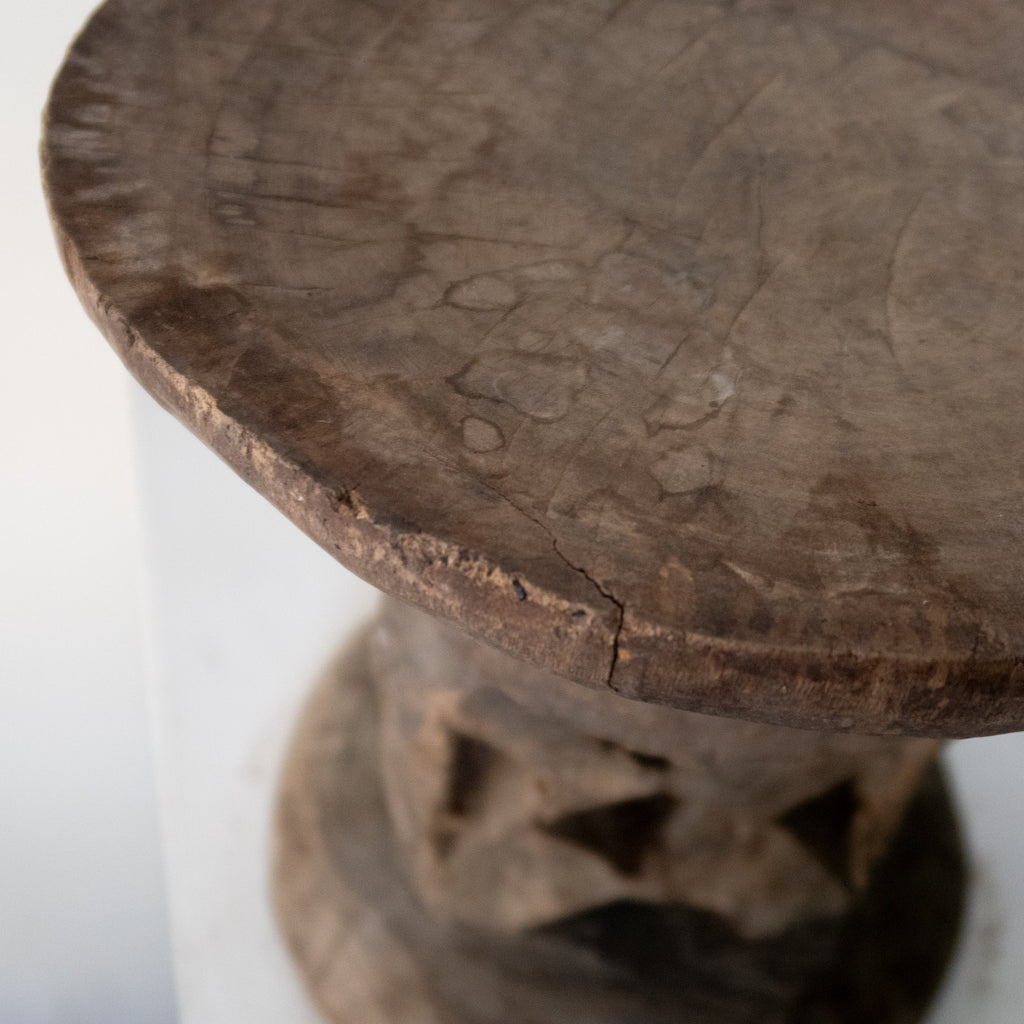 Carved primitive style wooden stool from the Shona people of Zimbabwe featuring openwork base and rustic craftsmanship — Hommes and Gardens, Furniture Collection, home decor, outdoor decorations, home design, luxury design, Landscape Architect, Interior Designer, Outdoor Living, Art, Furniture, Objects, Best Gifts, Nature, Backyard, Yard.