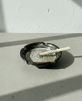 Signed Studio Pottery Ceramic Ashtray with Glazed Earth Tones – Handcrafted Artisan Work featuring a unique spiral design and notches. hommes + gardens estudio.
