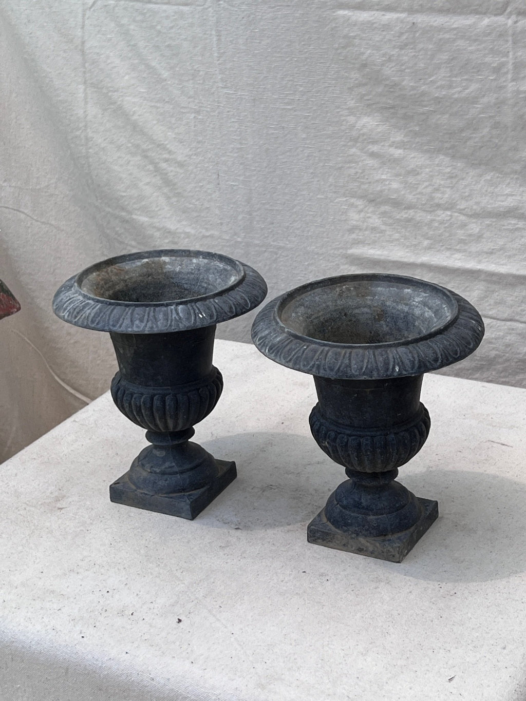 Antique French Neoclassical cast iron urn jardinieres featuring a rich patina and intricate craftsmanship, ideal for classic gardens or interiors — Hommes and Gardens, Pots + Vessels Collection, Landscape Architect, Interior Designer, Outdoor Living, Outdoor Decorations, Home Decor, Home Design, Luxury Design, Art, Furniture, Objects, Best Gifts, Nature, Backyard, Yard.