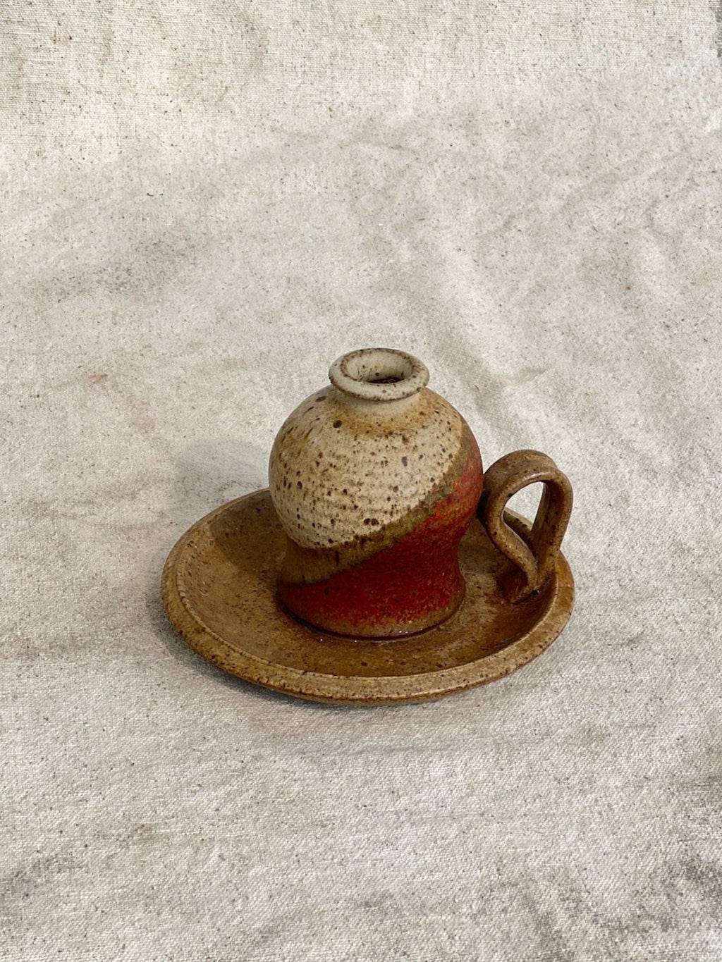 Vintage Chamber Stick Candle Holder Glazed Stoneware on a textured background, perfect for adding charm to any decor. hommes + gardens estudio.