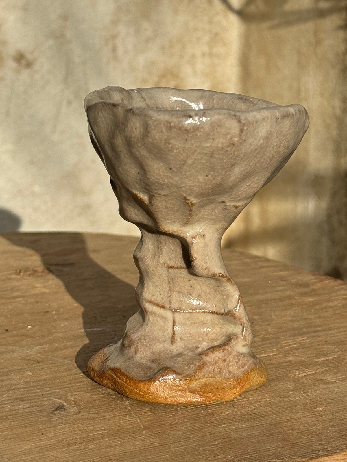 Vintage Naïve Art Pottery Goblet with Hand Pressed Stem Signed Mary on a wooden surface, showcasing a whimsical design. hommes + gardens estudio.