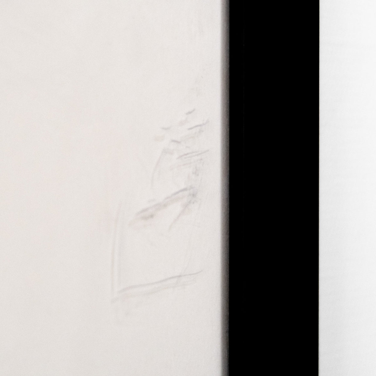 Close-up of the edge of a frame showing a subtle imperfection, possibly a scratch or smudge. hommes + gardens estudio.