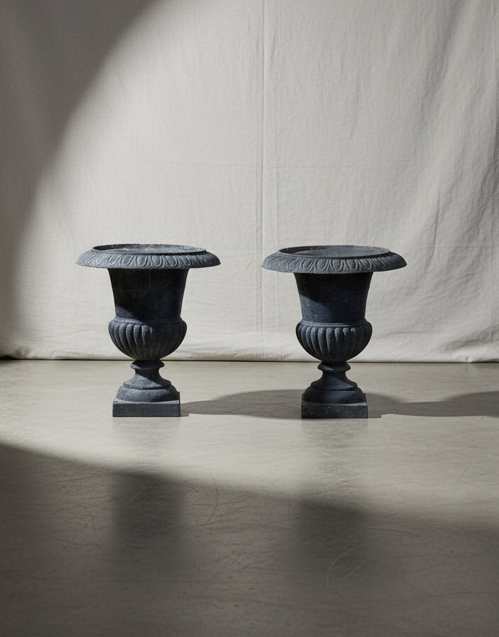 Pair of early 20th-century French Neoclassical cast iron urn planters with antique charcoal patina, exuding timeless elegance for indoor or outdoor spaces — Hommes and Gardens, Pots + Vessels Collection, Landscape Architect, Interior Designer, Outdoor Living, Outdoor Decorations, Home Decor, Home Design, Luxury Design, Art, Furniture, Objects, Best Gifts, Nature, Backyard, Yard.
