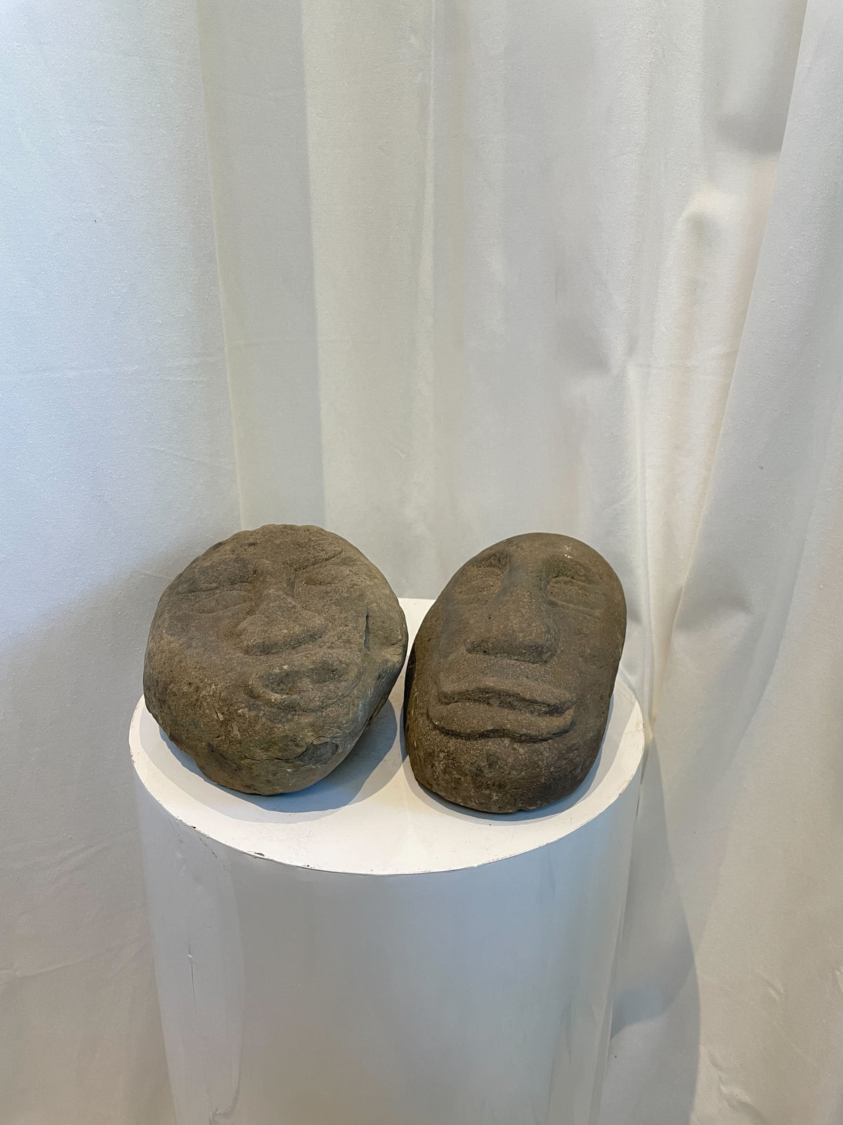 Primitive stone face sculptures handcrafted from natural stone, evoking indigenous art and cultural expression — Hommes and Gardens, home decor, garden decor, outdoor decorations, home design, luxury design, Landscape Architect, Interior Designer, Outdoor Living, Art, Furniture, Objects, Best Gifts, Nature, Backyard, Yard.