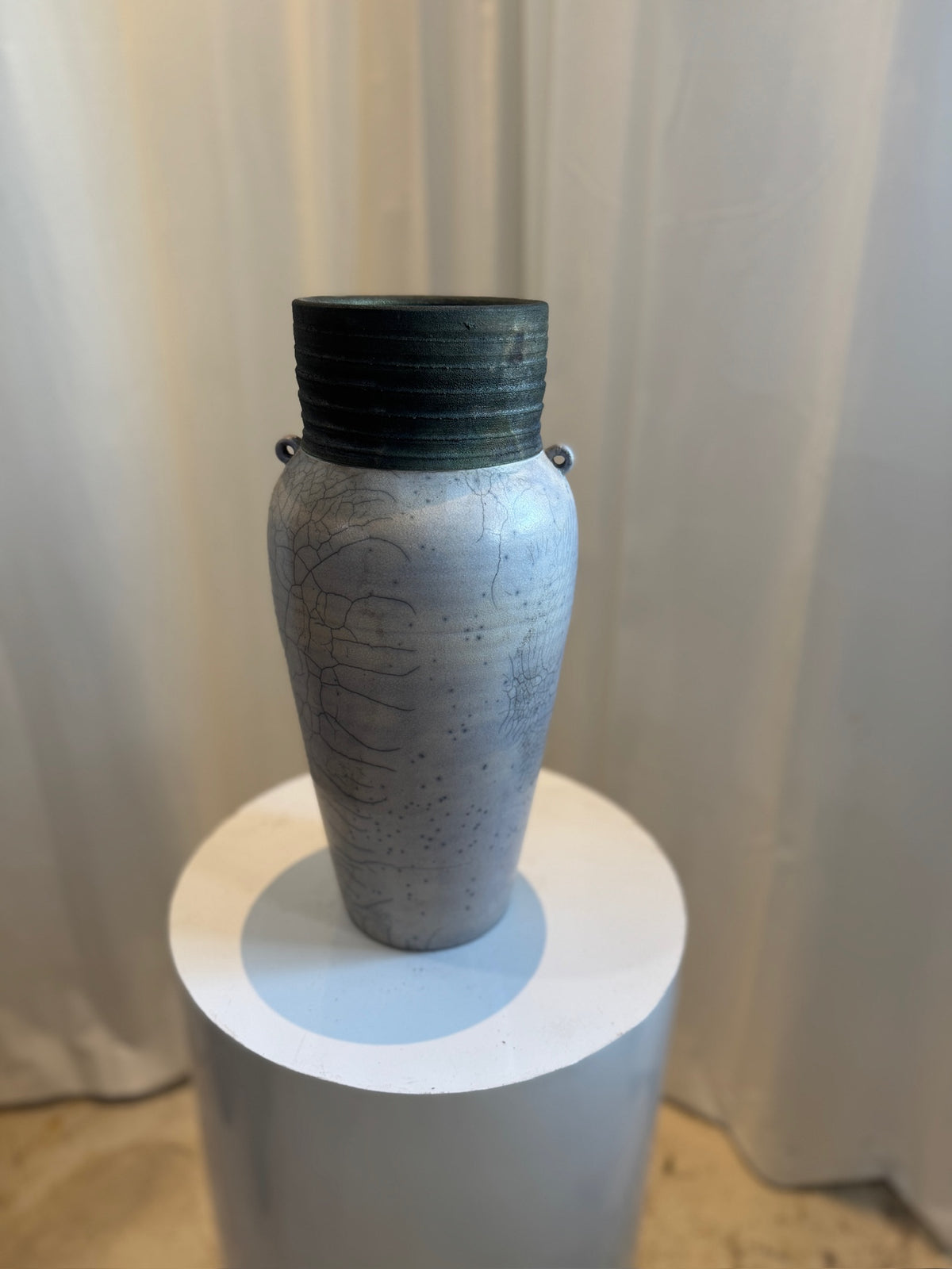 Raku handcrafted ceramic vase with crackled glaze, ribbed rim, and drainage hole, featuring organic textures and loop handles for artistic display — Hommes and Gardens, Vases + Vessels Collection, Landscape Architect, Interior Designer, Outdoor Living, Art, Furniture, Objects, Best Gifts, Nature, Backyard, Yard, Outdoor Decorations, Home Decor, Home Design, Luxury Design.