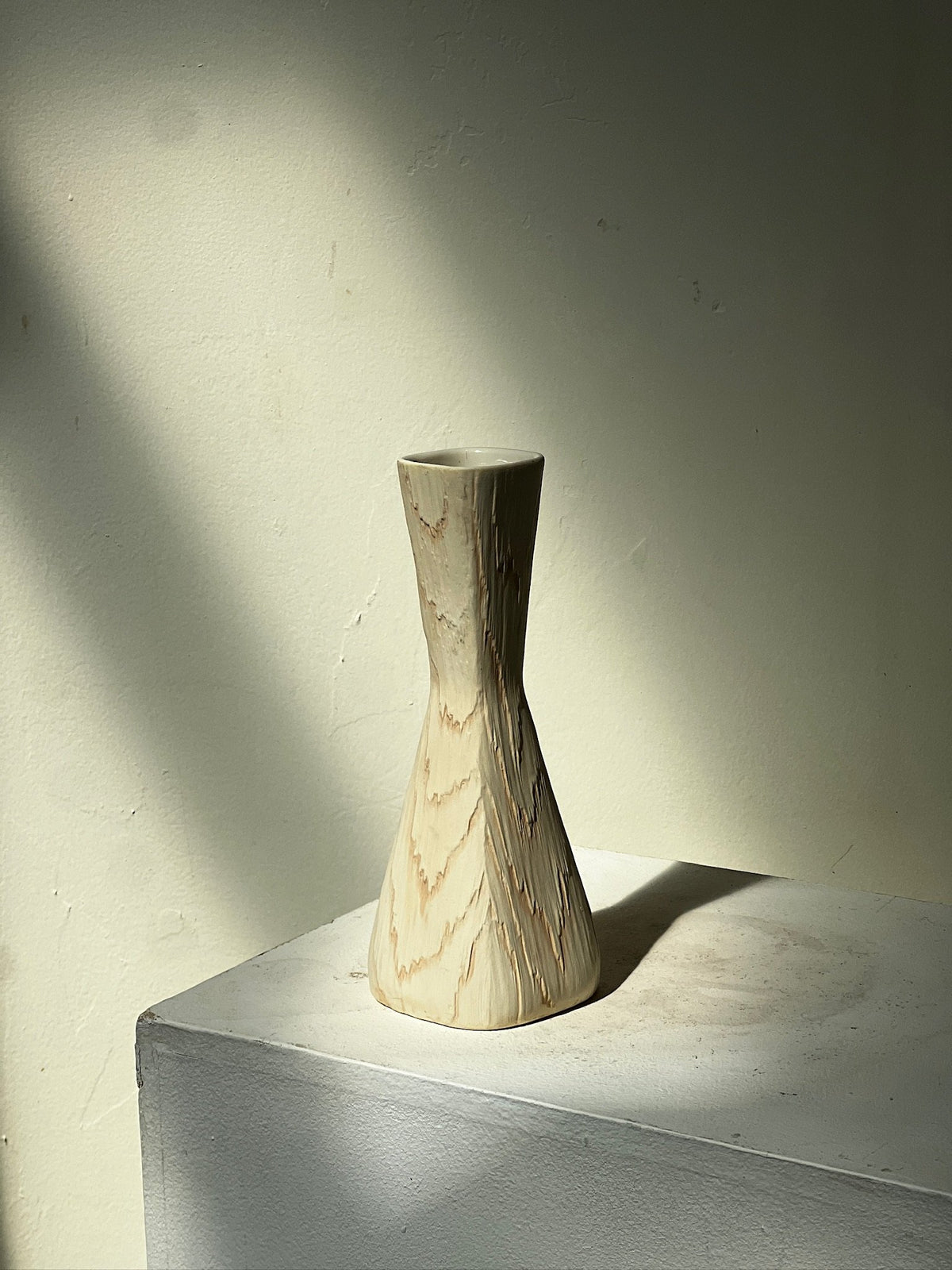 Vintage Mid Century Fairy Wood Vase by Shawnee USA on a pedestal with soft lighting, showcasing its unique design. hommes + gardens estudio.