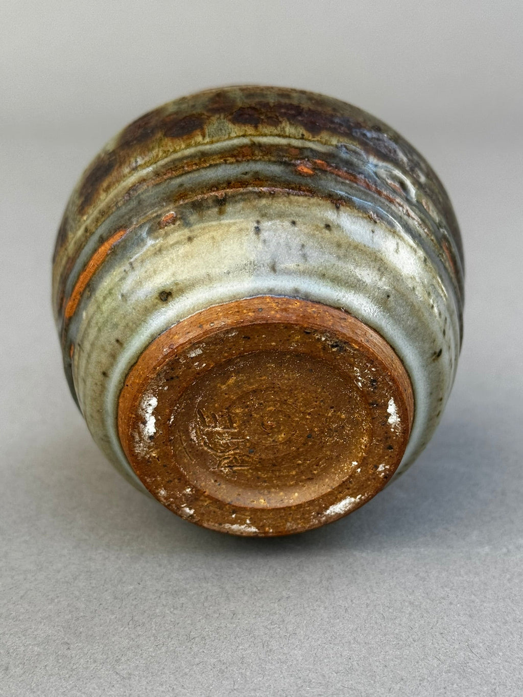 studio pottery urn vase close up showing ash gray and terracotta tones