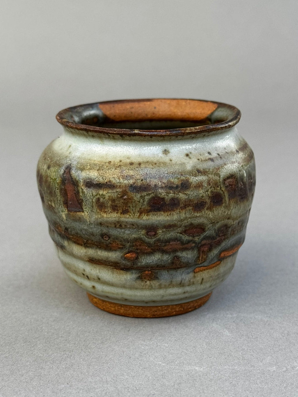 ceramic urn vase with ash glaze texture and natural tonal variation