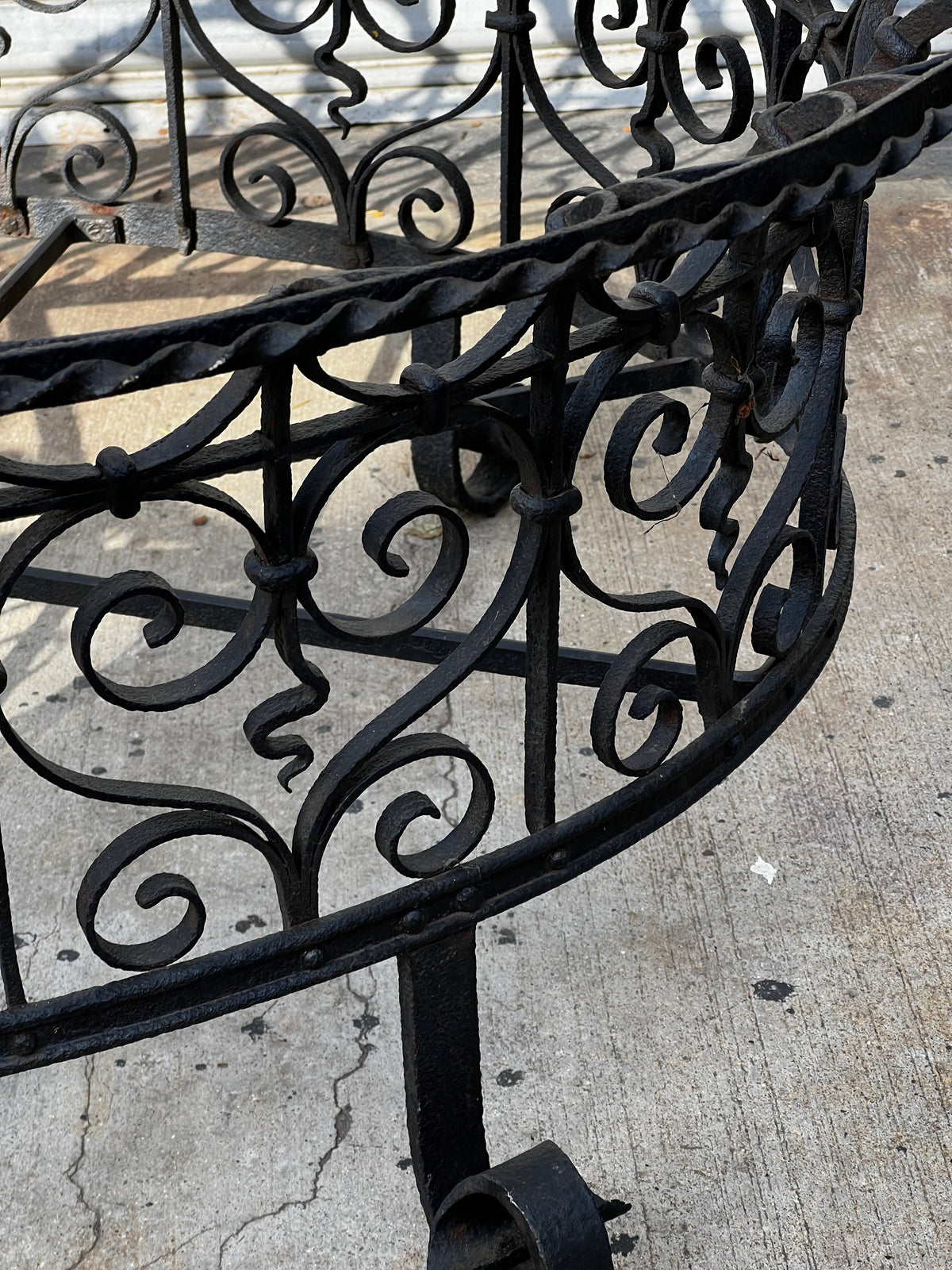 Detail of decorative scrollwork on a Victorian Oval Wrought Iron Plant Holder at hommes + gardens estudio.