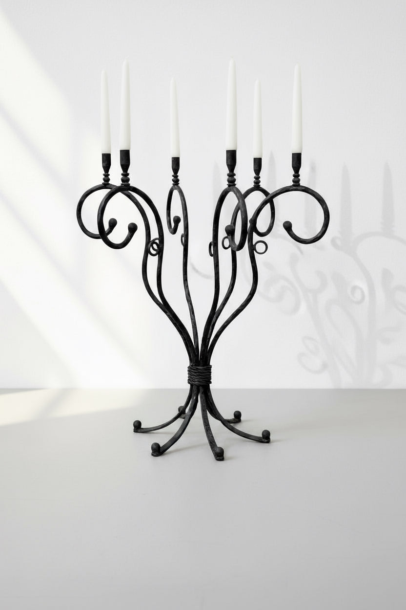 Vintage Scrolled Cast Iron Candelabrum featuring six elegant scrolled arms in a sophisticated design. hommes + gardens estudio.