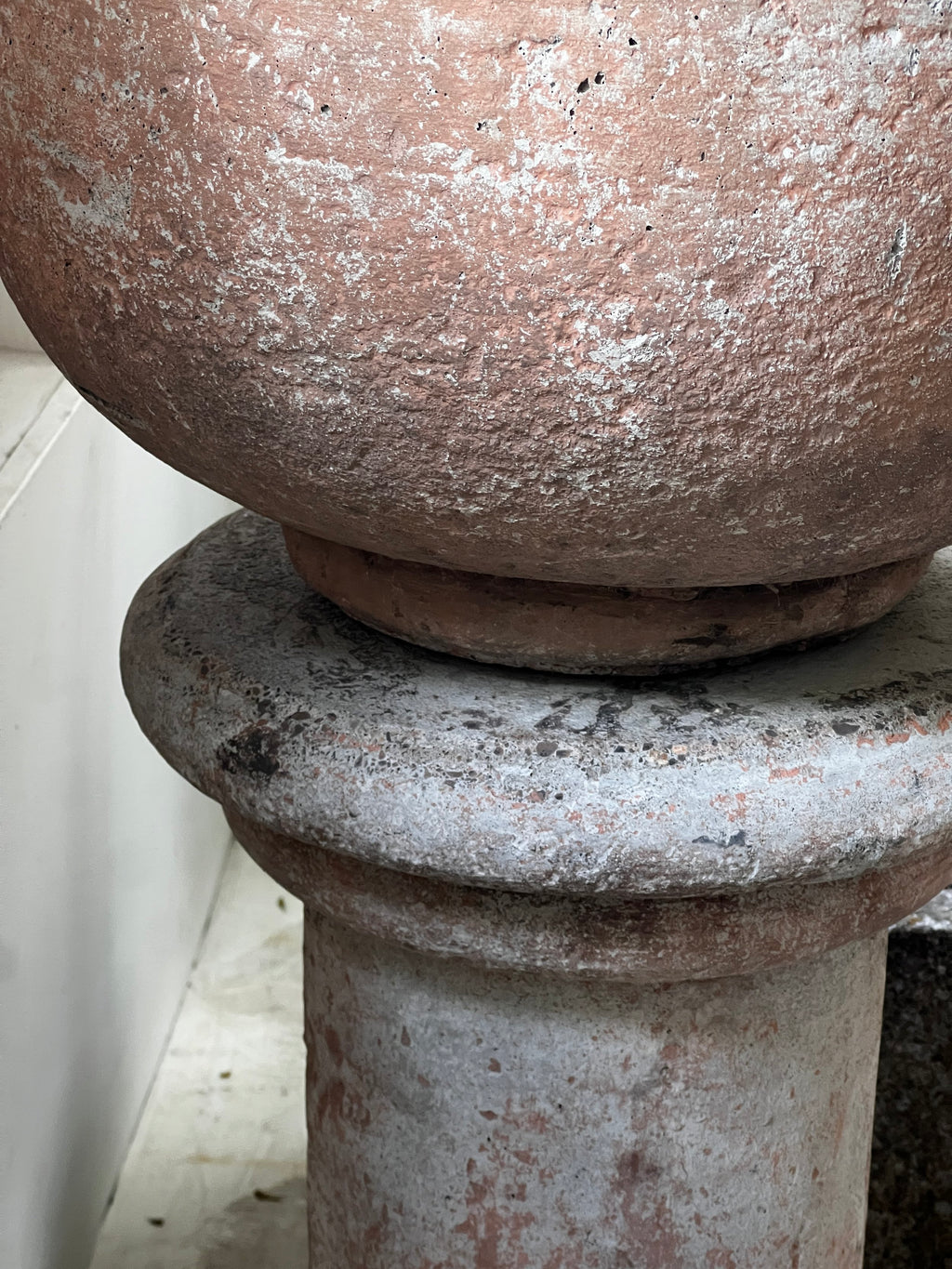 Close-up of a Vintage Sevilla Stone Planter w/ Pedestal showcasing its elegant details and weathered texture. hommes + gardens estudio.