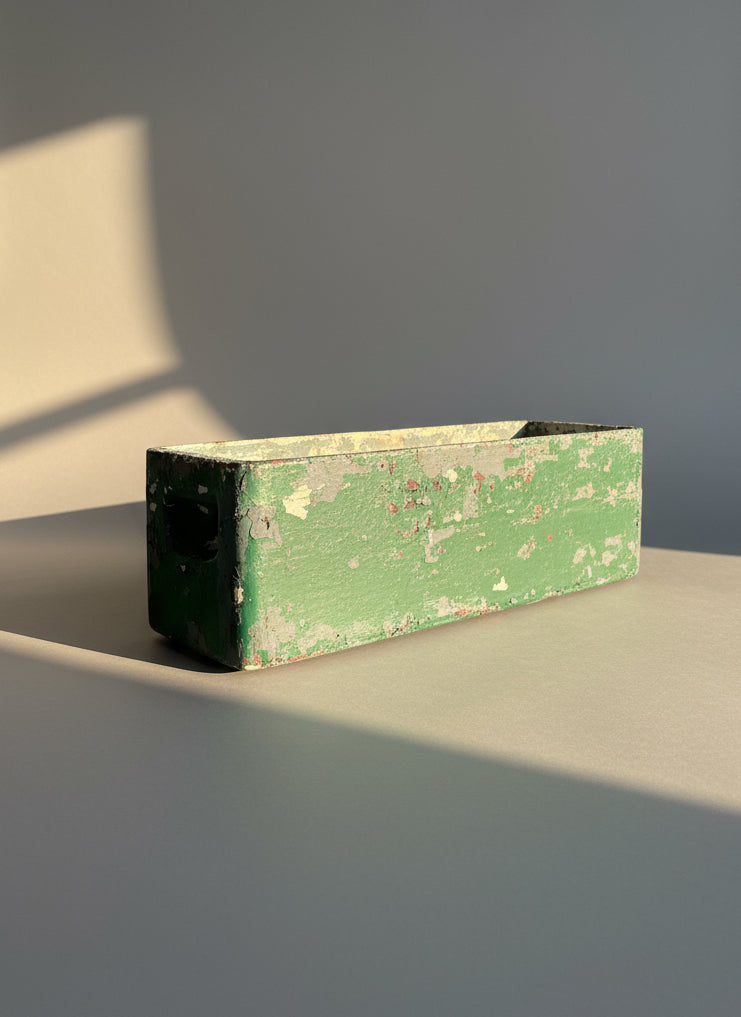 Willy Guhl Vintage Fiber Cement Planter Rectangular with Distressed Green Paint in natural light, showcasing its aged patina. hommes + gardens estudio.