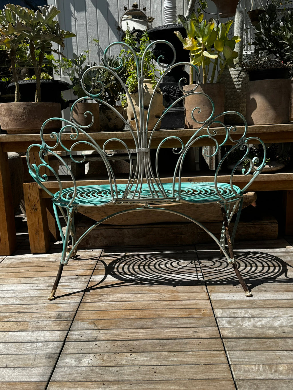 Whimsical Vintage Wrought Iron Peacock Garden Bench – Ornate Scrollwork in a garden setting, showcasing intricate design details. hommes + gardens estudio.