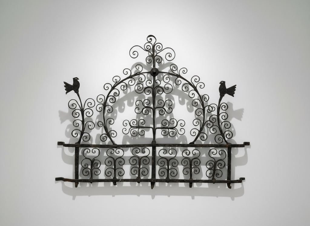 Antique 17th-Century Spanish Style Wrought Iron Wall Rack with Bird Motif showcasing intricate scrollwork and bird designs. hommes + gardens estudio.