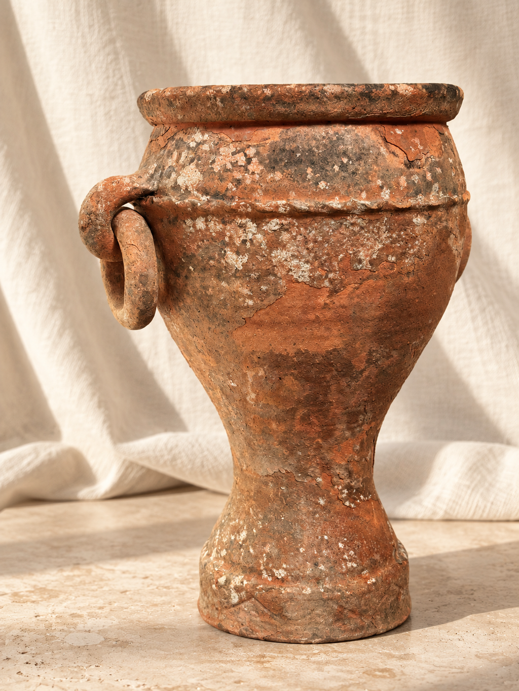 Side view of terracotta amphora planter with tapered foot